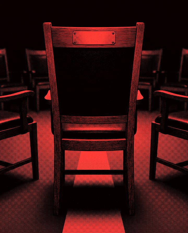 A single council chair seen from behind, a blank engraved plaque on its top rail